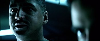 Movie still from “The Sum of All Fears” (2002), directed by Phil Alden Robinson – A person's ear and ear plugs; Close Up shot, Over the shoulder angle
