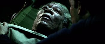 Movie still from “The Sum of All Fears” (2002), directed by Phil Alden Robinson – An old man with a beard is looking up; Close Up shot, Overhead angle