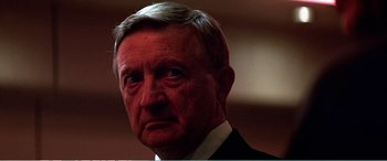 Movie still from “The Sum of All Fears” (2002), directed by Phil Alden Robinson – An older man wearing a suit and tie; Close Up shot, Low angle
