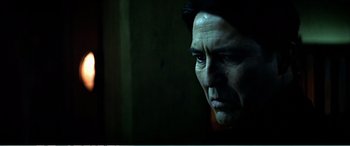 Movie still from “The Sum of All Fears” (2002), directed by Phil Alden Robinson – A person looking at the camera; Close Up shot, Low angle