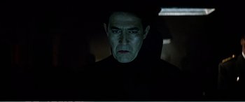 Movie still from “The Sum of All Fears” (2002), directed by Phil Alden Robinson – A person in a dark room; Close Up shot, Low angle