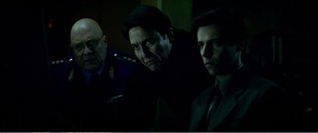 Movie still from “The Sum of All Fears” (2002), directed by Phil Alden Robinson – A group of men standing next to each other in the dark; Close Up shot, Over the shoulder angle