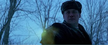 Movie still from “The Sum of All Fears” (2002), directed by Phil Alden Robinson – A man is holding a flashlight in the snow; Close Up shot, Low angle