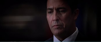 Movie still from “The Sum of All Fears” (2002), directed by Phil Alden Robinson – A person wearing a suit and tie; Close Up shot, Low angle