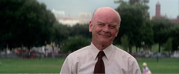 Movie still from “The Sum of All Fears” (2002), directed by Phil Alden Robinson – An older man wearing a white shirt and a brown tie; Close Up shot, Low angle