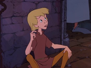 Movie still from “The Sword in the Stone” (1963), directed by Wolfgang Reitherman – A young blonde haired boy sitting on the ground; Medium shot, High angle