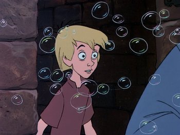 Movie still from “The Sword in the Stone” (1963), directed by Wolfgang Reitherman – A cartoon of a boy with bubbles in front of a brick wall; Medium shot, Low angle