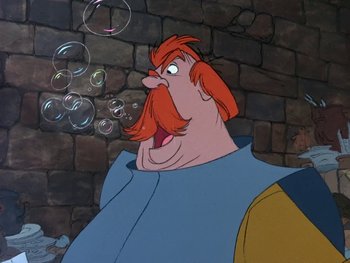 Movie still from “The Sword in the Stone” (1963), directed by Wolfgang Reitherman – A man with red hair and a long beard blowing bubbles; Close Up shot, Low angle