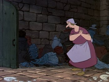 Movie still from “The Sword in the Stone” (1963), directed by Wolfgang Reitherman – An animated picture of an old woman standing in front of a brick wall; Medium shot, Low angle