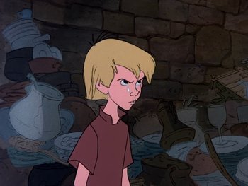 Movie still from “The Sword in the Stone” (1963), directed by Wolfgang Reitherman – A young blonde boy standing in front of a wall; Medium shot, High angle