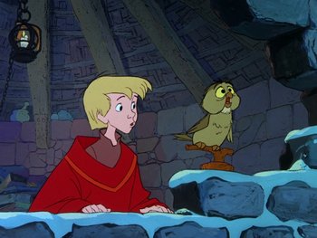 Movie still from “The Sword in the Stone” (1963), directed by Wolfgang Reitherman – A cartoon of a boy and a bird in a cave; Medium shot, Low angle