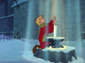 Movie still from “The Sword in the Stone” (1963), directed by Wolfgang Reitherman – A man kneeling down in front of a sword in the snow; Wide shot, Low angle