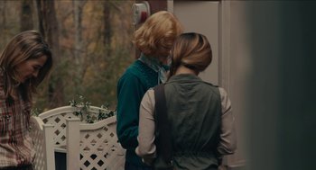Movie still from “The Taking of Deborah Logan” (2014), directed by Adam Robitel – Two women standing next to each other on a porch; Medium shot, Over the shoulder angle