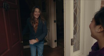 Movie still from “The Taking of Deborah Logan” (2014), directed by Adam Robitel – A woman in a jacket and jeans is smiling; Medium shot, Over the shoulder angle