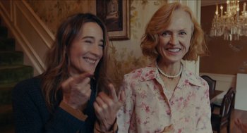 Movie still from “The Taking of Deborah Logan” (2014), directed by Adam Robitel – Two women are smiling and clapping for the camera; Medium shot, Over the shoulder angle