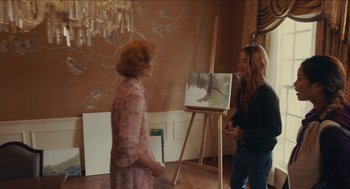 Movie still from “The Taking of Deborah Logan” (2014), directed by Adam Robitel – Two women standing in front of an easel with a painting; Medium shot, Over the shoulder angle