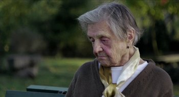 Movie still from “The Taking of Deborah Logan” (2014), directed by Adam Robitel – An older woman sitting on a park bench looking sad; Close Up shot, Over the shoulder angle