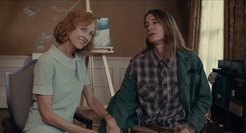 Movie still from “The Taking of Deborah Logan” (2014), directed by Adam Robitel – Two women sitting next to each other in front of a painting; Medium shot, High angle