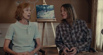 Movie still from “The Taking of Deborah Logan” (2014), directed by Adam Robitel – Two women sitting in front of a painting; Medium shot, Over the shoulder angle