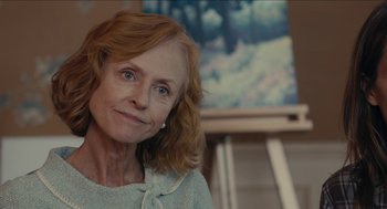 Movie still from “The Taking of Deborah Logan” (2014), directed by Adam Robitel – An older woman is smiling for the camera; Close Up shot, Over the shoulder angle