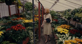Movie still from “The Taking of Deborah Logan” (2014), directed by Adam Robitel – A woman standing in front of many flowers; Wide shot, High angle