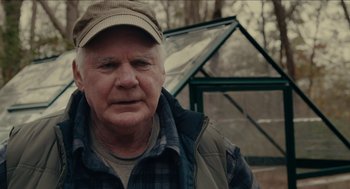 Movie still from “The Taking of Deborah Logan” (2014), directed by Adam Robitel – An older man wearing a hat and a jacket; Close Up shot, Over the shoulder angle