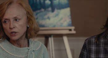 Movie still from “The Taking of Deborah Logan” (2014), directed by Adam Robitel – Two people sitting in front of an easel in front of a painting; Close Up shot, Over the shoulder angle