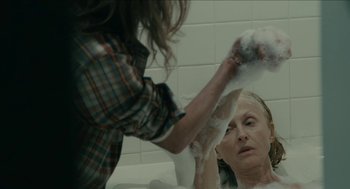 Movie still from “The Taking of Deborah Logan” (2014), directed by Adam Robitel – A woman in a bath tub getting a bath from another woman; Medium shot, Over the shoulder angle
