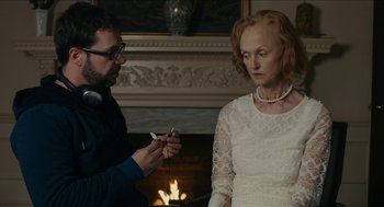 Movie still from “The Taking of Deborah Logan” (2014), directed by Adam Robitel – A man and a woman in front of a fireplace; Close Up shot, Over the shoulder angle
