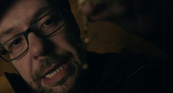 Movie still from “The Taking of Deborah Logan” (2014), directed by Adam Robitel – A person with a beard wearing glasses; Extreme Close Up shot, High angle