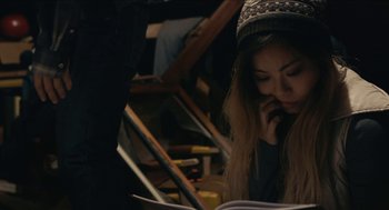 Movie still from “The Taking of Deborah Logan” (2014), directed by Adam Robitel – A woman sitting at a table looking at a book on a cell phone; Close Up shot, High angle