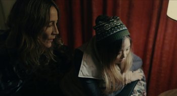 Movie still from “The Taking of Deborah Logan” (2014), directed by Adam Robitel – A woman sitting next to a child in a room; Close Up shot, High angle