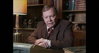 Movie still from “The Taking of Deborah Logan” (2014), directed by Adam Robitel – An older man sitting at a desk in front of books; Close Up shot, High angle