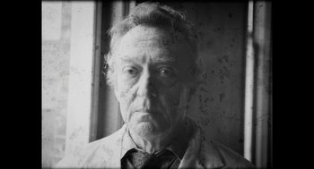 Movie still from “The Taking of Deborah Logan” (2014), directed by Adam Robitel – An old man with a beard wearing a shirt and tie; Close Up shot, Low angle