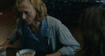 Movie still from “The Taking of Deborah Logan” (2014), directed by Adam Robitel – An older woman sitting at a table with a bowl of food; Close Up shot, Over the shoulder angle