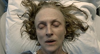 Movie still from “The Taking of Deborah Logan” (2014), directed by Adam Robitel – An older woman laying on a bed with her eyes closed; Close Up shot, Overhead angle