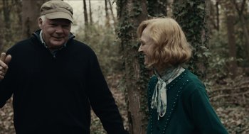 Movie still from “The Taking of Deborah Logan” (2014), directed by Adam Robitel – A man and a woman holding hands in the woods; Medium shot, Over the shoulder angle