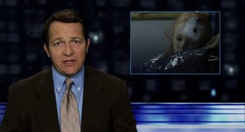 Movie still from “The Taking of Deborah Logan” (2014), directed by Adam Robitel – A man in a suit and tie in front of a tv screen; Close Up shot, Over the shoulder angle