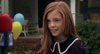 Movie still from “The Taking of Deborah Logan” (2014), directed by Adam Robitel – A girl with long red hair wearing a purple dress; Close Up shot, Over the shoulder angle