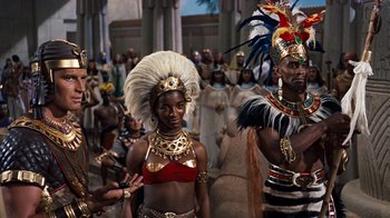 Movie still from “The Ten Commandments” (1956), directed by Cecil B. DeMille – A couple of people that are dressed up in costumes; Medium shot, High angle