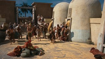 Movie still from “The Ten Commandments” (1956), directed by Cecil B. DeMille – A group of people standing next to each other on a beach; Extreme Wide shot, High angle
