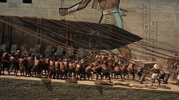 Movie still from “The Ten Commandments” (1956), directed by Cecil B. DeMille – A group of people standing on top of a brick wall; Extreme Wide shot, Overhead angle