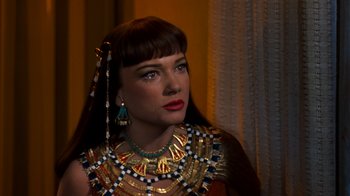 Movie still from “The Ten Commandments” (1956), directed by Cecil B. DeMille – A woman wearing a necklace of gold and turquoise; Close Up shot, Over the shoulder angle