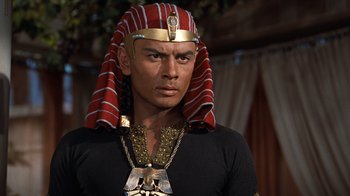 Movie still from “The Ten Commandments” (1956), directed by Cecil B. DeMille – A man wearing a gold and red headpiece; Close Up shot, High angle