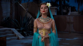 Movie still from “The Ten Commandments” (1956), directed by Cecil B. DeMille – A woman in a costume with a flower in her hair; Medium shot, Over the shoulder angle