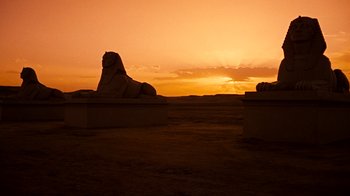 Movie still from “The Ten Commandments” (1956), directed by Cecil B. DeMille – The sun is setting behind a large sphinx statue; Extreme Wide shot, Low angle