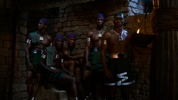 Movie still from “The Ten Commandments” (1956), directed by Cecil B. DeMille – A group of men standing next to each other in front of a brick wall; Medium shot, Low angle