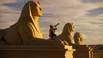Movie still from “The Ten Commandments” (1956), directed by Cecil B. DeMille – A man standing on top of a statue holding a bat; Extreme Wide shot, Low angle