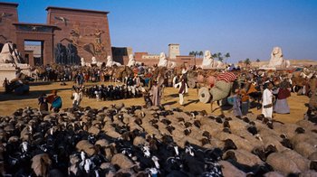 Movie still from “The Ten Commandments” (1956), directed by Cecil B. DeMille – A crowd of people standing next to a herd of sheep; Extreme Wide shot, High angle
