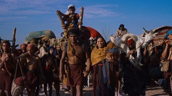 Movie still from “The Ten Commandments” (1956), directed by Cecil B. DeMille – A group of people walking down a street; Wide shot, High angle
